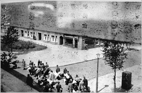 Jews carry luggage to an assembly point before deportation to the Westerbork camp